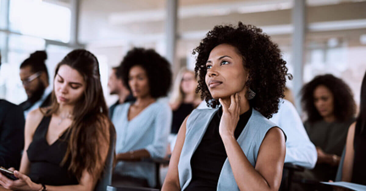 Woman thinking during a lecture