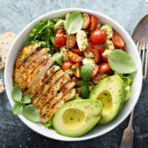 grilled chicken salad with tomatoes, cucumbers, and avocado