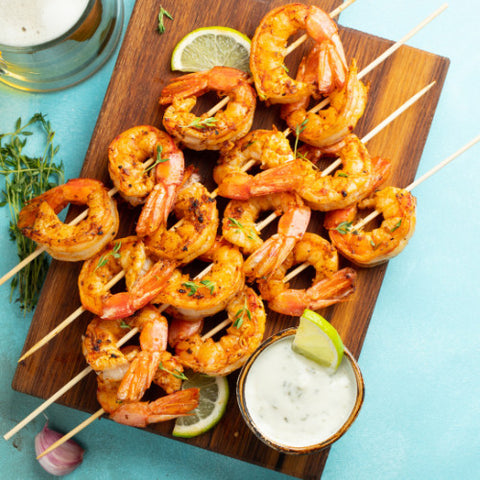 Lemon Garlic Shrimp Skewers on a light blue background.