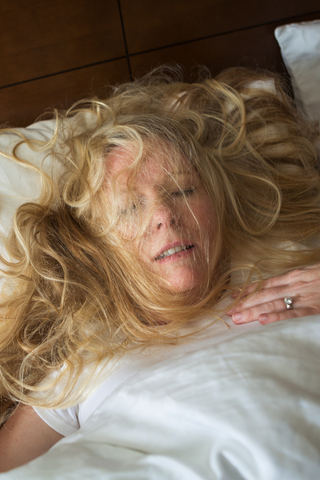 woman sweating profusely in bed.