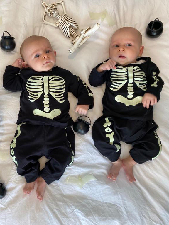 Baby boys wearing Halloween skeleton costumes