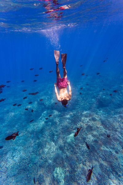 Man swimming underwater in hawaii