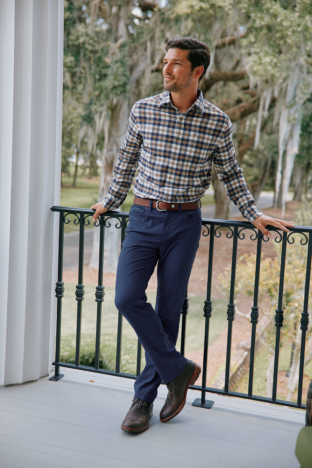 Man in button-down shirt and navy dress pants.