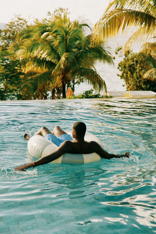 Guy floating in a pool