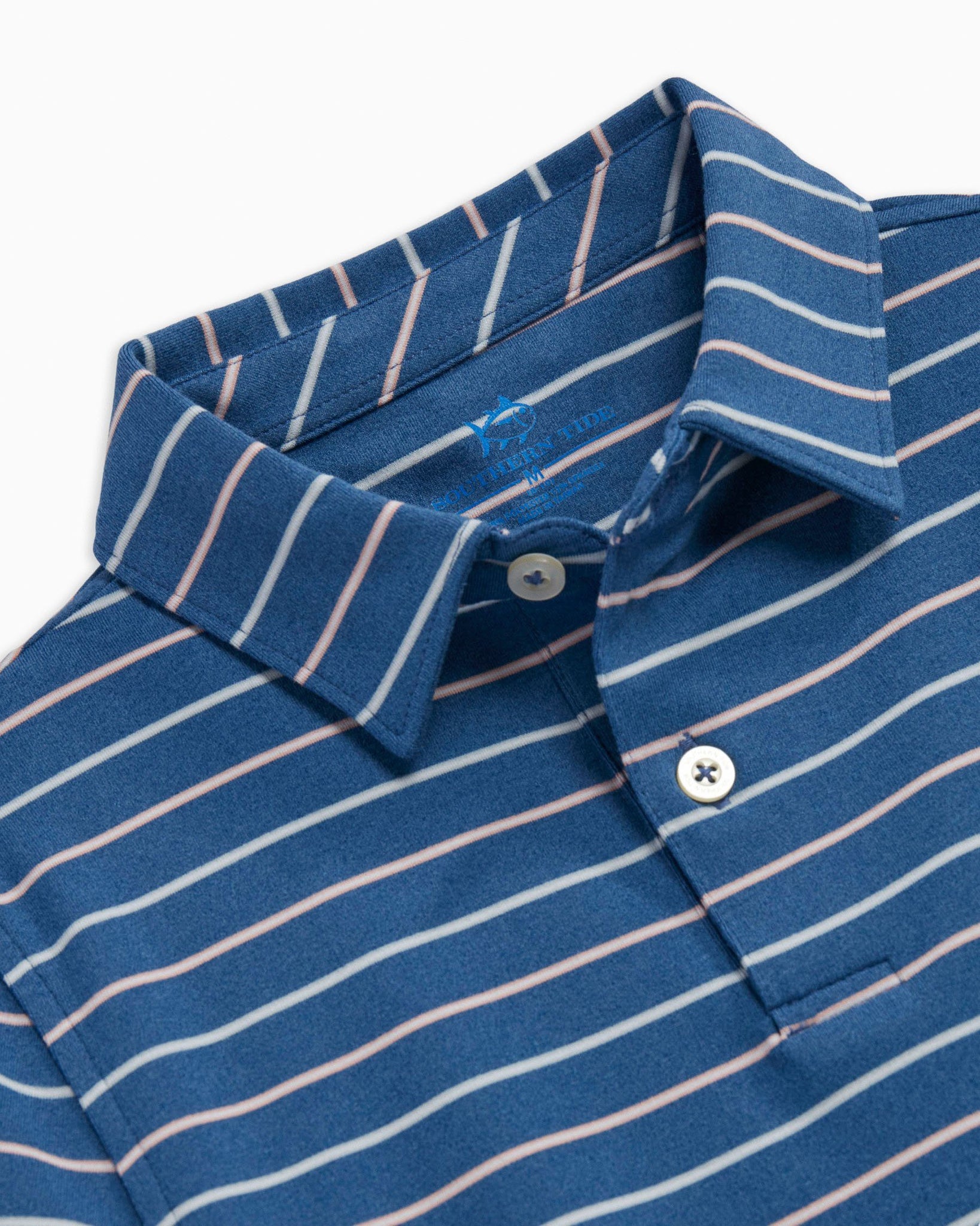 The detail of the Boys Breaker Ryder Stripe Performance Polo by Southern Tide - Heather Seven Seas Blue