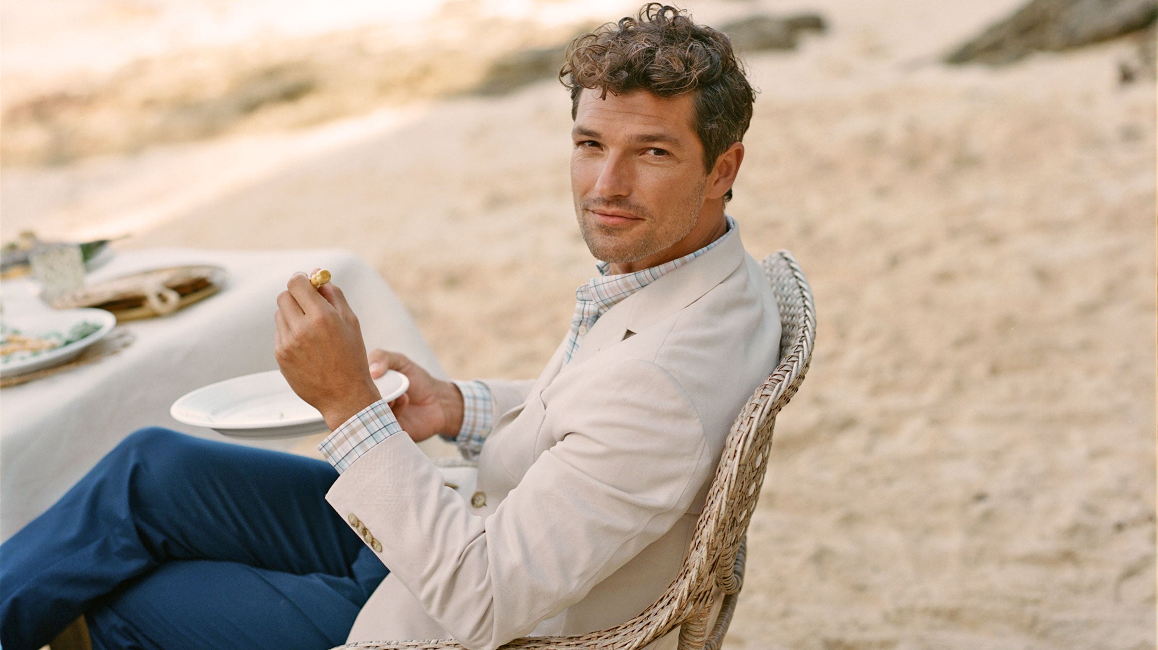 man in chair in a perfectly pale khaki blazer