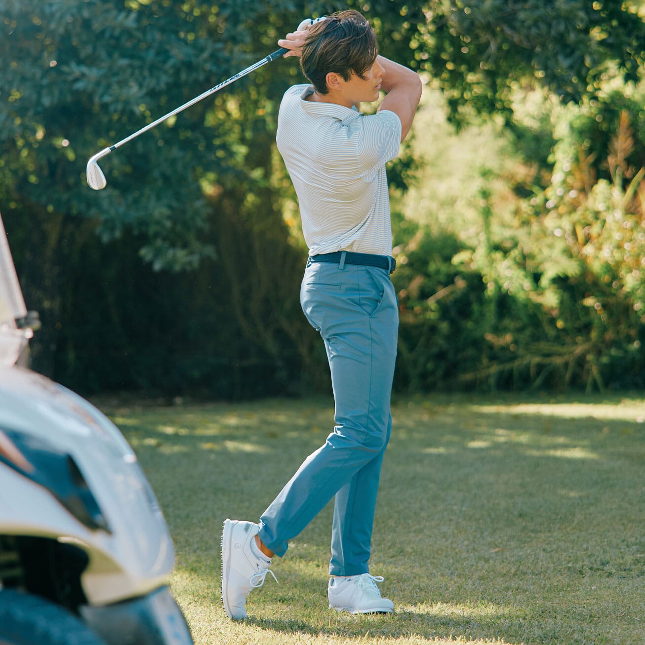 Man playing golf in versatile performance apparel