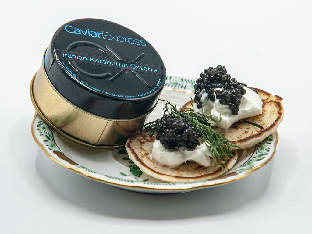 Fresh blinis with creme fraiche and iranian karaburun ossetra caviar
