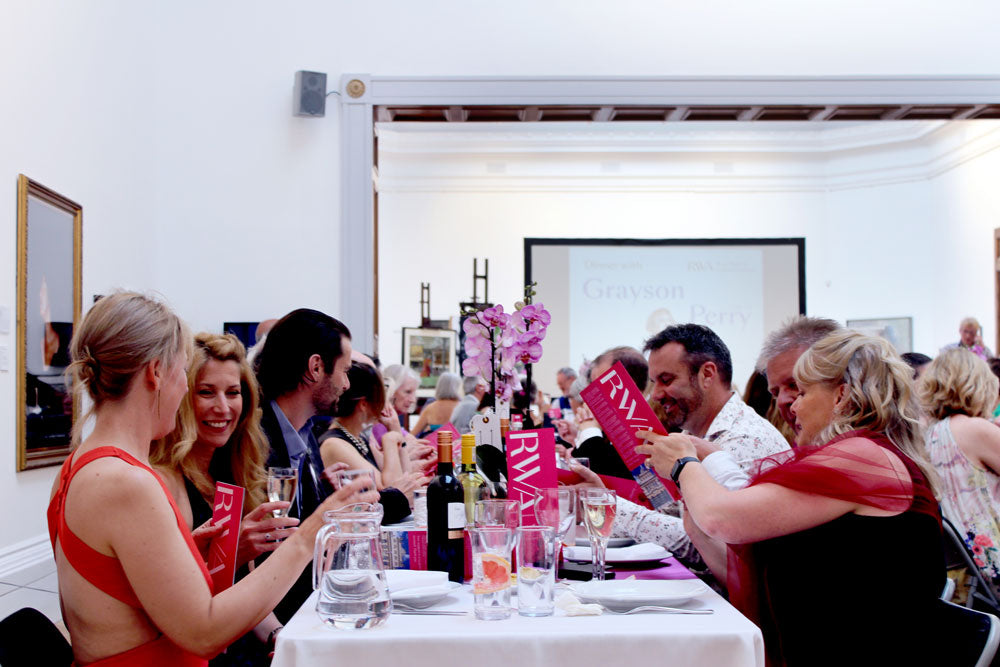 Guest seated at long tabled in the Sharples Gallery