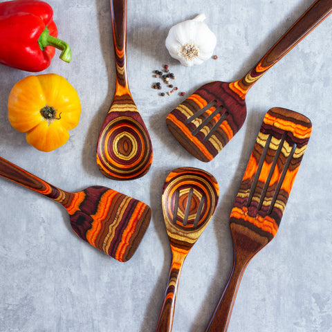 Fall colored birch wood cooking utensils with bell peppers and garlic