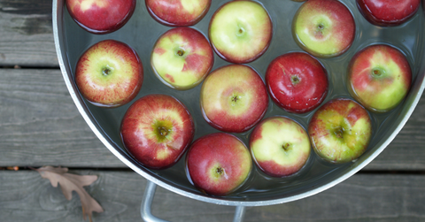 A pail of apples and water for a game of bobbing for apples.