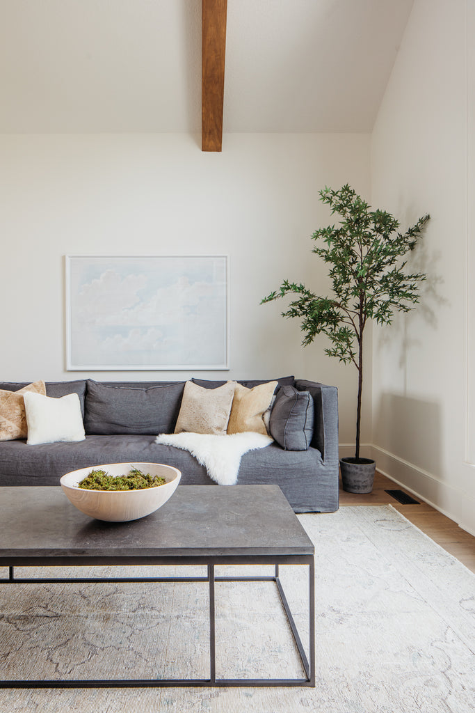 Verellen Lawrence sofa and bluestone coffee table on an upside down vintage persian rug.