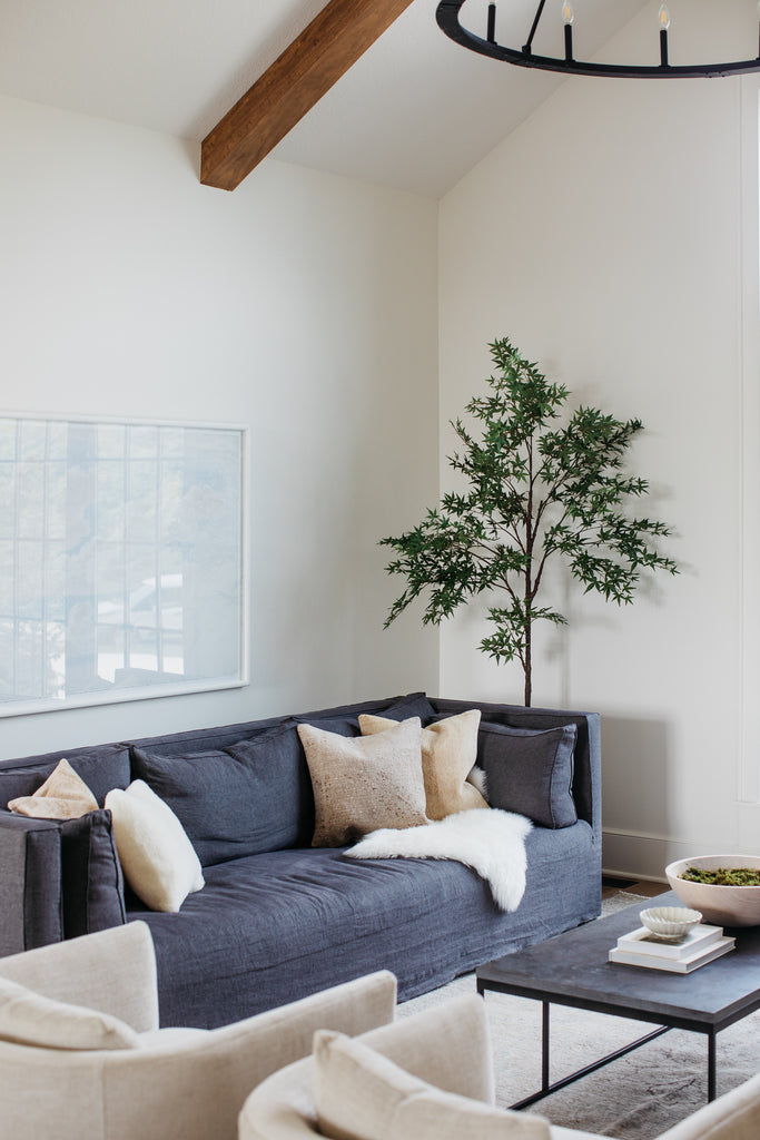 Verellen Lawrence slipcovered sofa in moody charcoal linen, cloud art, Verellen Sullivan chairs, and bluestone coffee table.