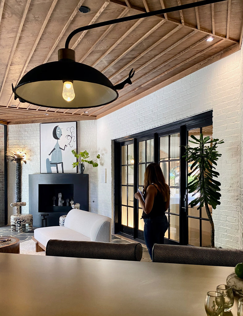 Sunroom Bar by Tracy Hardenburg Designs  Okay -- I'm totally making up names for these spaces!  Loved the high top table with the built in ice bucket...white brick walls...incredible warm wooden ceiling detail...black fireplace with art...