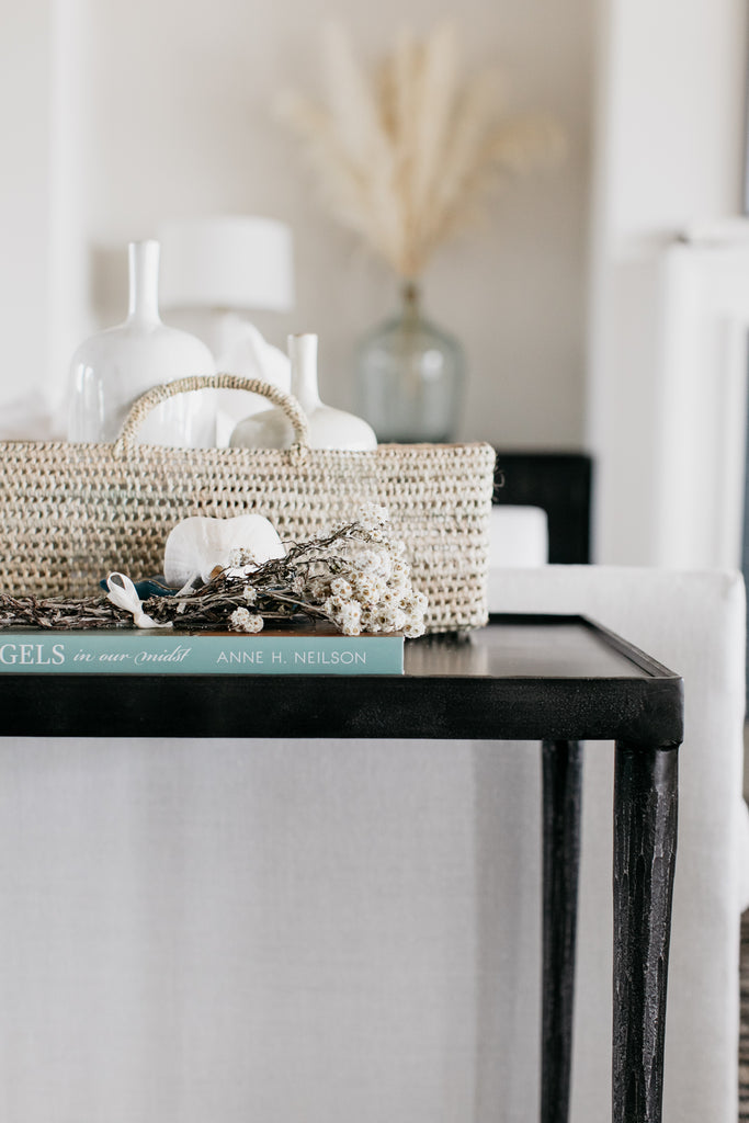 The black Lancaster side table is big enough for a deep 40" Verellen Thibaut sofa and works beautifully with this contemporary Moroccan rug, and rustic oversized coffee table. The side table generously holds the palm leaf baskets and coffee table book-sized Angels in our Midst, by Anne Neilson.