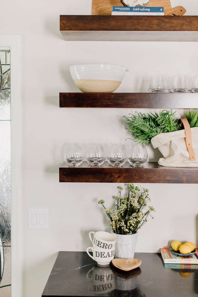 The custom-built open shelving in the kitchen is such a fun contrast to the cabinets. This is such a gorgeous way to show off cute ceramic and glassware along with seasonal decor and flowers.