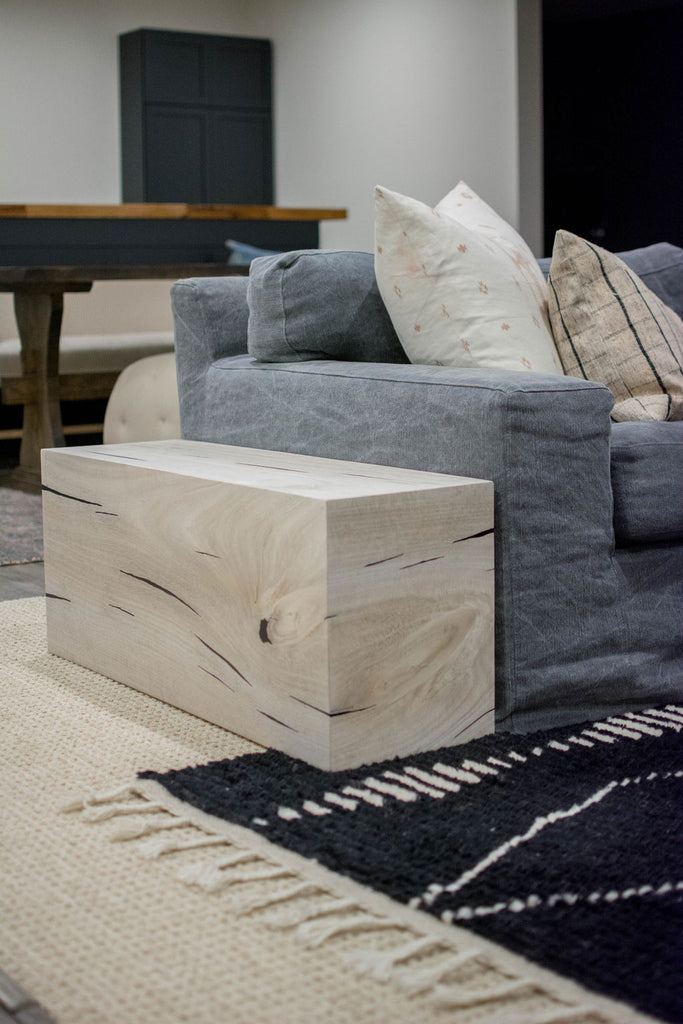 To keep with the goal of natural fibers and textures, this Yukas side table is a wonderful way to add natural elements as a side table along the sofa.
