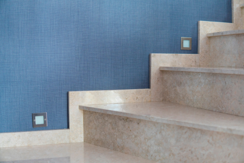 white marble stairs with lights with blue walls