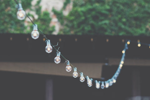 string lights hanging outside on a daytime 