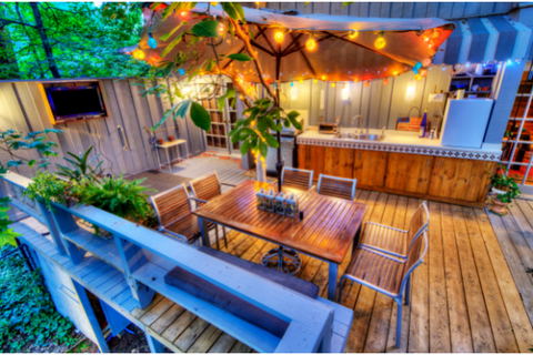 wooden patio with mini bar and chairs and table with lights