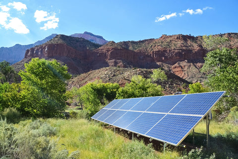 solar panels looking shined by sun and surrounded by large mountains