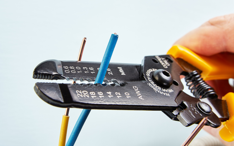 stripper tool cuts wires during installation of electrical wiring