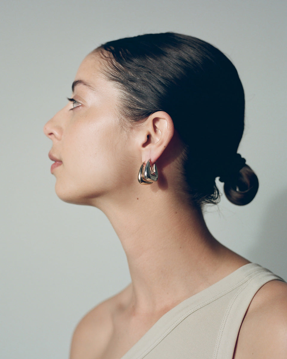 Model wearing J. Hannah Tetra Hoops II earrings in silver and 14k gold