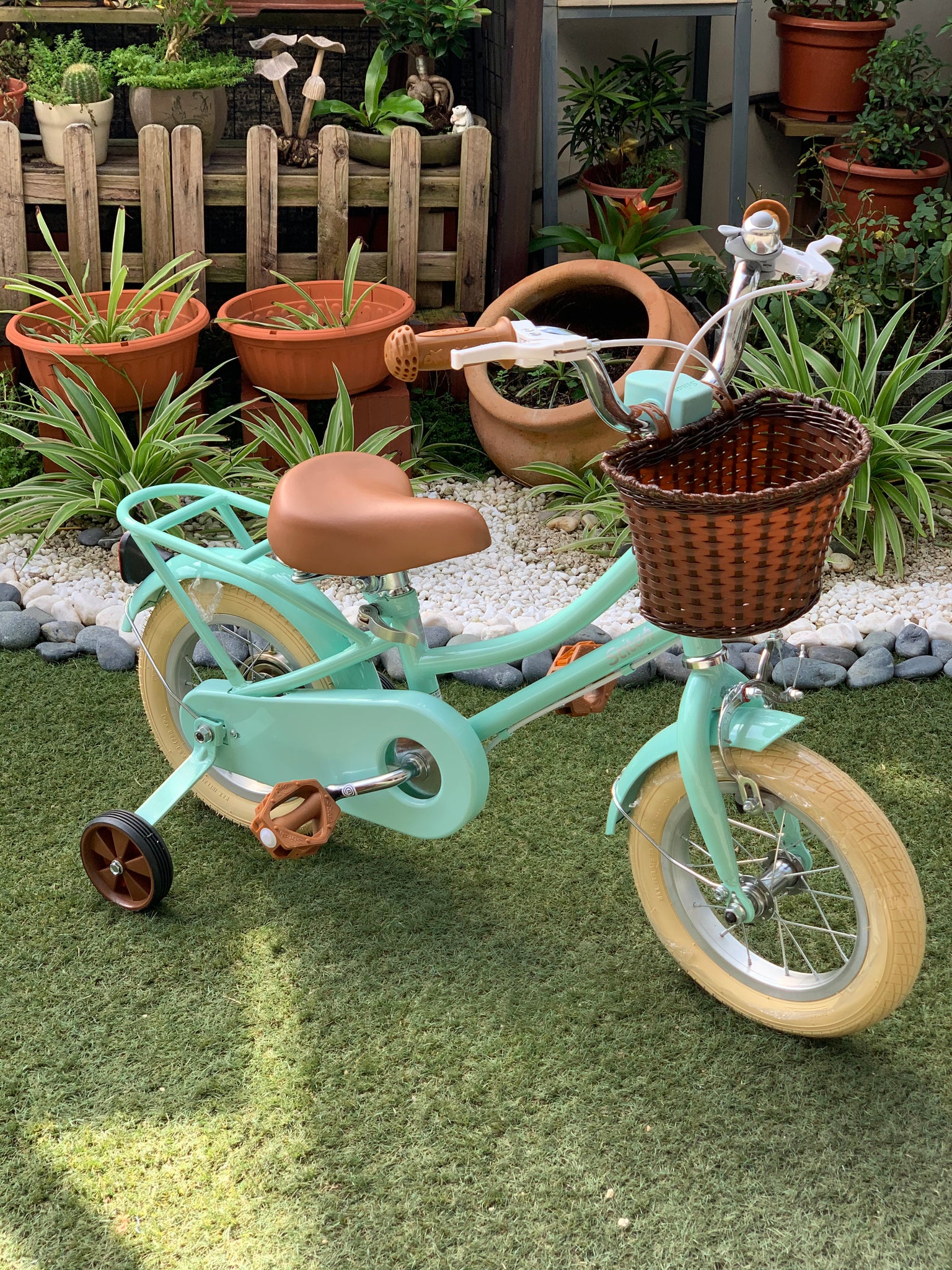 green bike with training wheels