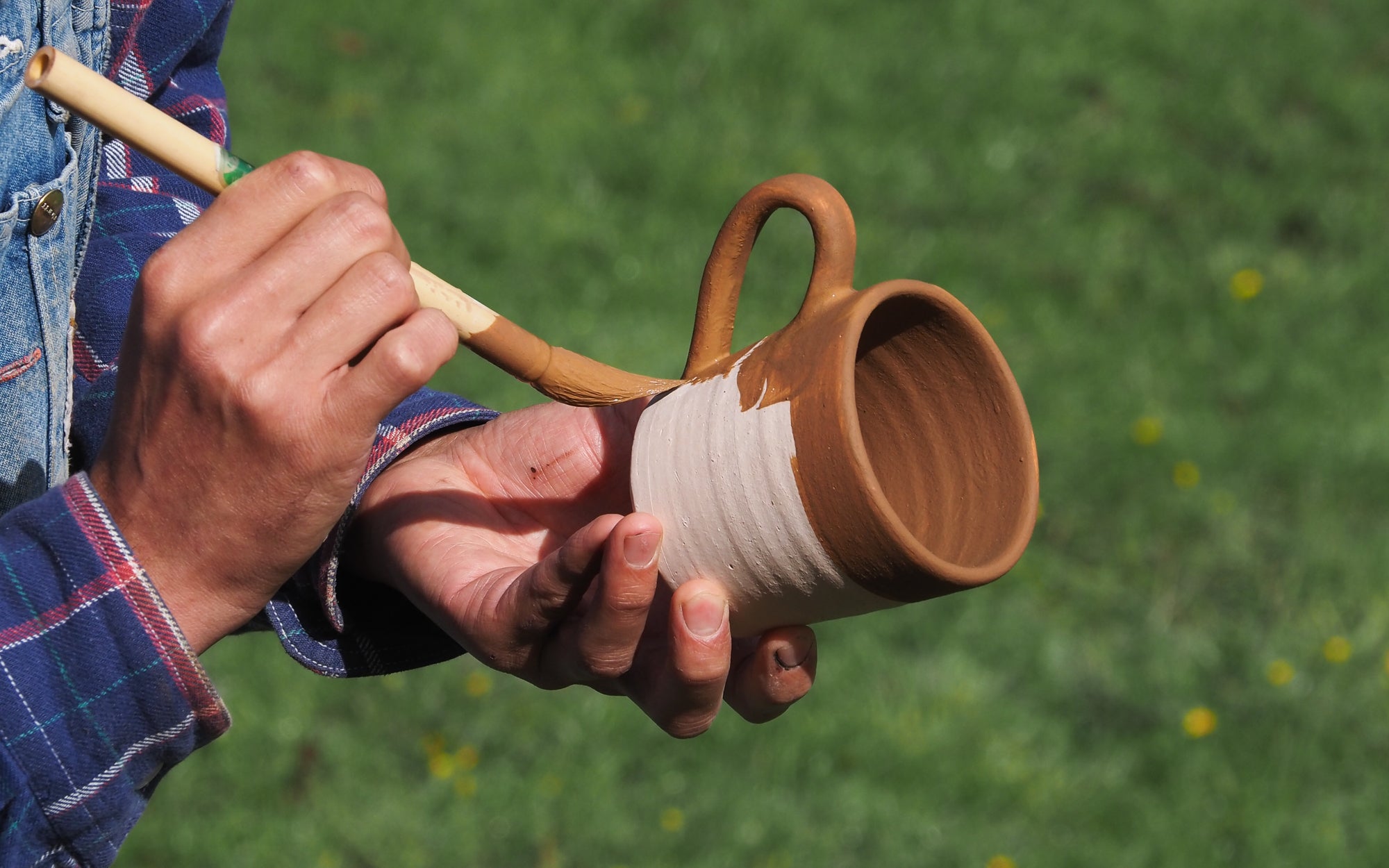 Slip getting painted on a Studio Cup