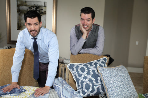 jonathan and drew scott standing over their fabric line