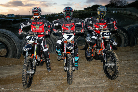 Risk racing's european riders lined up sitting one there dirt bikes posing in risk racing ventilate v2 gear. Showing off their moto style which involves not having kick stands on their bikes.