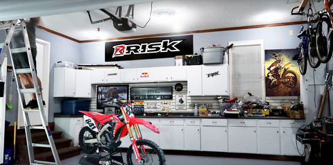 dirt bike in a shop that is lit by risk racing/stkr's MPi system.