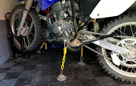 Dirt bike anchored with D-Rings in a trailer. This particular set up required the user to combine straps D-Rings and a wheel chock to secure the bike
