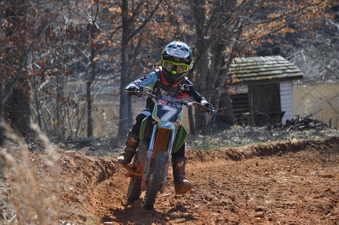 Young risk racing rider training on a motocross track