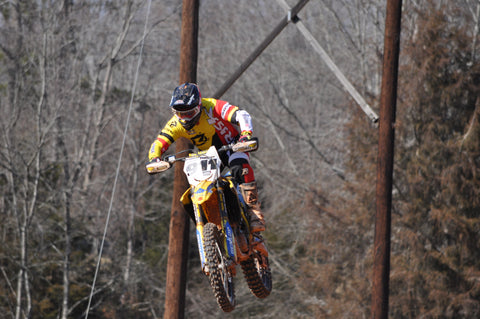 RISK Racing rider caught mid air during a training session at a motocross track wearing the new risk racing gear