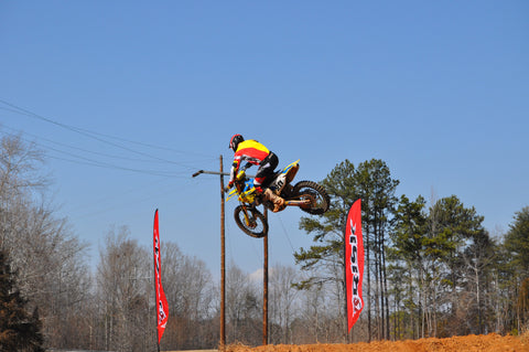 Risk racing rider training at a motocross track. The rider utilizes yoga in their training.