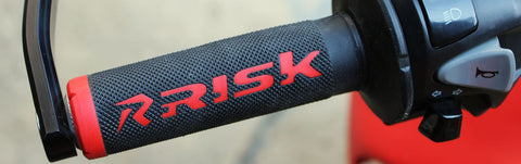 Risk racing fusion 2.0 red/black motocross grips mounted on an off-road motorcycle