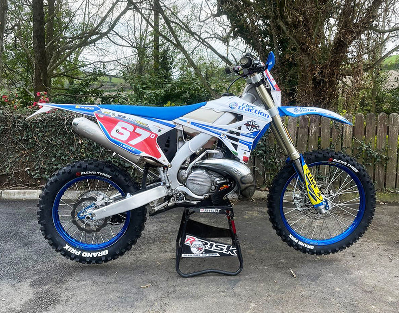 2-stroke adventure bike sitting on an ATS stand by Risk Racing wearing Plews Tyres EN1 Grand Prix