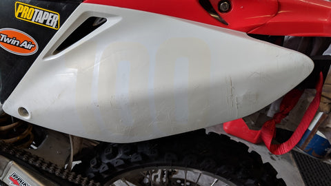Dirt bike plastics after old graphics have been removed. The graphics leave behind this adhesive residue that has to be removed before installing new graphics