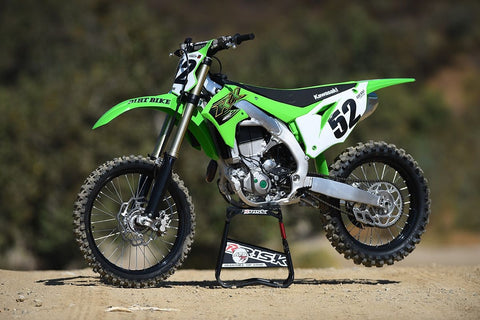 2022 kawasaki 450 resting on a risk racing a.t.s. stand at dirt bike magazines 2022 shoot out.