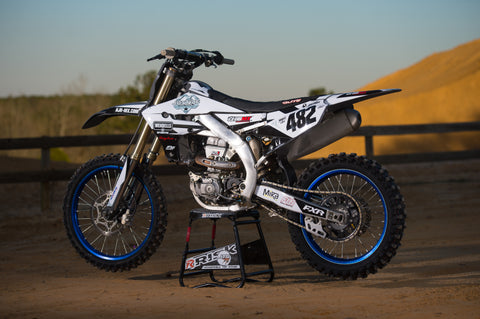 Dirt bike resting on a risk racing A.T.S. Stand at a motocross track. 