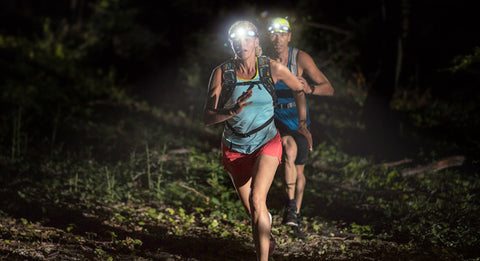People trail running at night wearing STKR Headlamp Pro's