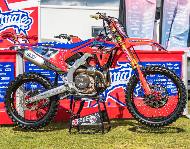 Honda dirt bike sitting on a Risk Racing ATS Stand and is wearing Plews Tyres.