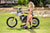 September's Risk Racing Moto Model Denna Lynn posing in various bikinis & Risk Racing Jerseys next to a dirt bike that's sitting on a Risk Racing ATS stand - Pose #10