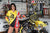 August's Risk Racing Moto Model Samantha Heady posing in various bikinis & Risk Racing Jerseys next to a dirt bike that's sitting on a Risk Racing ATS stand - Pose #28