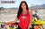 La modelo de moto de marzo de Risk Racing, Amber Juliana, con una camiseta roja sin mangas con margaritas de Risky moto delante de una moto de motocross, primer plano, cercada blanca de la pista de MX al fondo