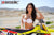 Risk Racing's March Moto Model Amber Juliana wearing a white bikini standing behind a motocross bike - close up shot