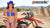 October's Risk Racing Moto Model Dani Hamilton posing in various bikinis and Risk Racing Jerseys next to a dirt bike that's sitting on a Risk Racing ATS stand - Pose #34
