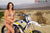 La modelo de moto de Risk Racing de octubre, Jessica Victorino, posa con varios bikinis y camisetas de Risk Racing junto a una moto de cross que está sentada en un soporte de Risk Racing RR1-Ride-On - Pose #40