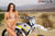 La modelo de moto de Risk Racing de octubre, Jessica Victorino, posa con varios bikinis y camisetas de Risk Racing junto a una moto de cross que está sentada en un soporte de Risk Racing RR1-Ride-On - Pose #41